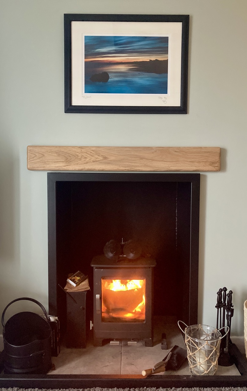 Wood-burning fireplace in the cottage living area