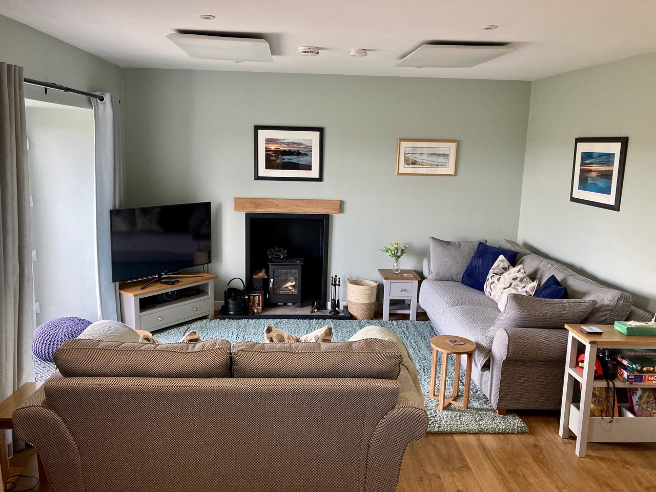 Bright living room with sofas and timber ceiling